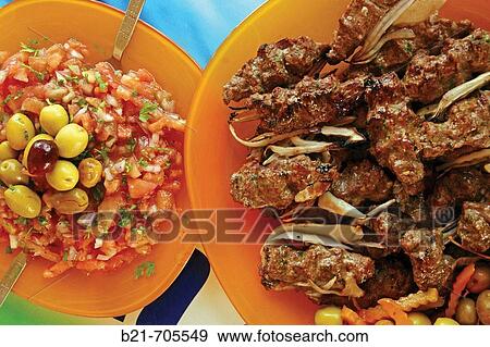 Tomatoes salad with olives and coriander and Kofta grilled meat View Large Photo Image Stock Photo - Tomatoes salad with olives and coriander and Kofta grilled meat. Fotosearch