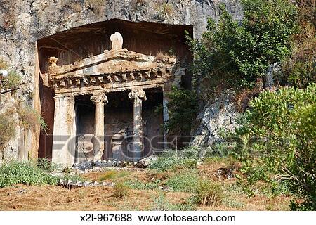 Stock Photo - Tomb of Amyntas - rock cut temple-type ancient Lycian tomb located in modern town of Fethiye Province of Mugla, Turkey. Fotosearch