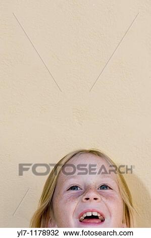 Top of a nine-year-old blond girl's head, laughing and looking up View Large Photo Image Stock Image - Top of a nine-year-old blond girl's head, laughing and looking up. Fotosearch
