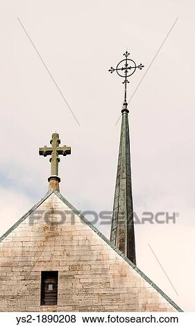 Stock Photo - Top of church with cross and spire. Fotosearch