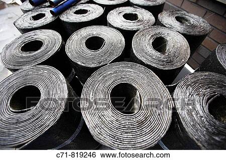 Tops of rolls of waterproof roofing paper on construction site View Large Photo Image Stock Photograph - Tops of rolls of waterproof roofing paper on construction site. Fotosearch
