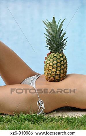 torso of a young woman stretched out beside a pool View Large Photo Image Stock Photography - torso of a young woman stretched out beside a pool. Fotosearch