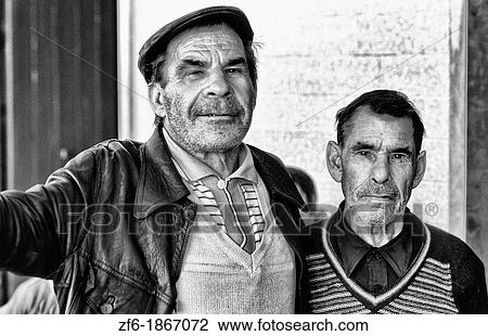 Tough and rough old fishermen relaxing at a bar in the village of Olmao in the Algarve in Southern Portugal in Europe. View Large Photo Image Stock Image - Tough and rough old fishermen relaxing at a bar in the village of Olmao in the Algarve in Southern Portugal in Europe.. Fotosearch