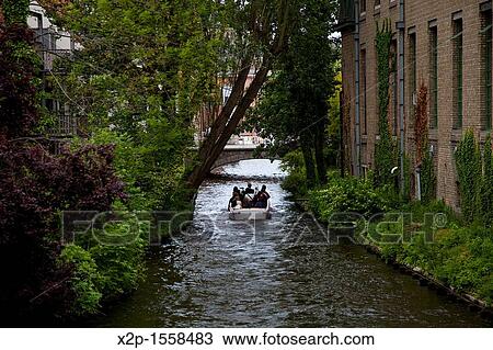 Tour boat in the canals of Bruges, Flanders, Belgium View Large Photo Image Stock Image - Tour boat in the canals of Bruges, Flanders, Belgium. Fotosearch