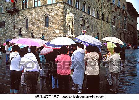 Tour group, in the rain, with umbrellas at the Palazzo Vecchio. Florence. Italy. View Large Photo Image Stock Photo - Tour group, in the rain, with umbrellas at the Palazzo Vecchio. Florence. Italy.. Fotosearch