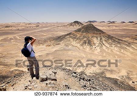 Tourist at Black Desert, Libyan Desert, Egypt View Large Photo Image Picture - Tourist at Black Desert, Libyan Desert, Egypt. Fotosearch