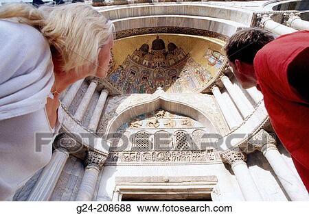 Tourist couple viewing murals on Basilica di San Marco. Venice. Italy View Large Photo Image Stock Photo - Tourist couple viewing murals on Basilica di San Marco. Venice. Italy. Fotosearch