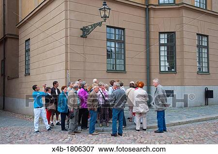 Tourist group at Slottsbacken square in front of Kungliga slottet the Royal Palace in Gamla Stan the old town Stockholm Sweden Europe View Large Photo Image Stock Photo - Tourist group at Slottsbacken square in front of Kungliga slottet the Royal Palace in Gamla Stan the old town Stockholm Sweden Europe. Fotosearch