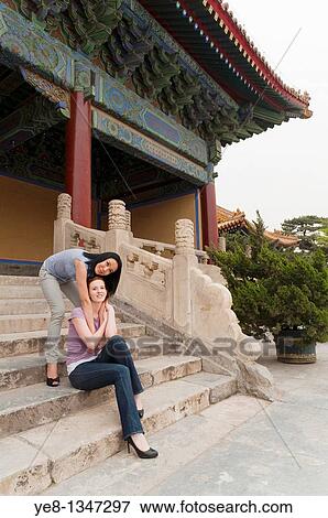 Tourist hugging her friend in The Forbidden City, Beijing, China, Asia MR View Large Photo Image Stock Photo - Tourist hugging her friend in The Forbidden City, Beijing, China, Asia MR. Fotosearch