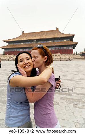 Tourist kissing her friend in front of the Hall for Worship Of Ancestors, The Forbidden City, Beijing, China, Asia MR View Large Photo Image Stock Image - Tourist kissing her friend in front of the Hall for Worship Of Ancestors, The Forbidden City, Beijing, China, Asia MR. Fotosearch