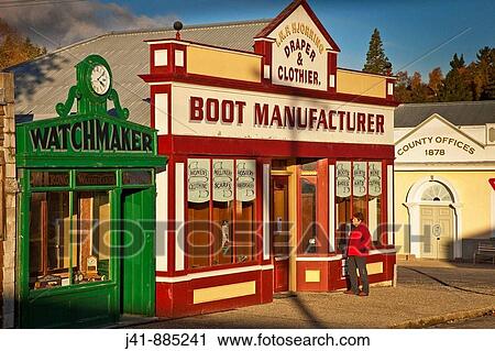 Stock Image - Tourist looks into historic Naseby museum, gold fields town, Central Otago, New Zealand. Fotosearch