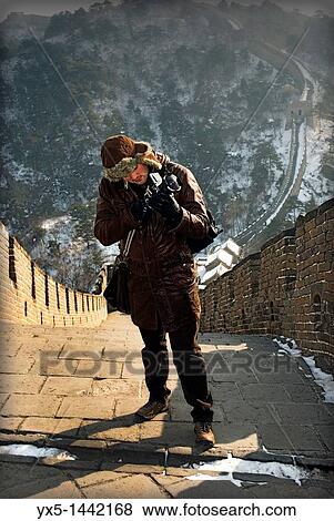 Stock Photo - Tourist photographer on Great Wall of China at Mutianyu. Fotosearch