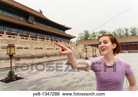 Tourist pointing something out in The Forbidden City, Beijing, China, Asia MR View Large Photo Image Stock Photo - Tourist pointing something out in The Forbidden City, Beijing, China, Asia MR. Fotosearch