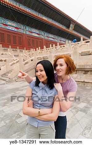 Tourist pointing something out to her friend in The Forbidden City, Beijing, China, Asia MR View Large Photo Image Stock Image - Tourist pointing something out to her friend in The Forbidden City, Beijing, China, Asia MR. Fotosearch