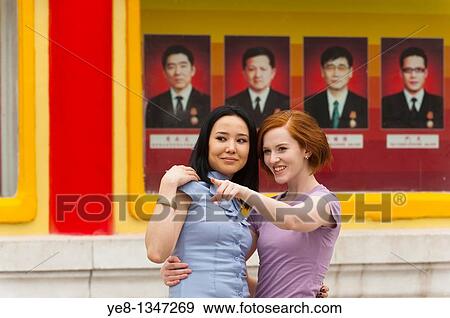 Tourist pointing something out to her friend in The Forbidden City, Beijing, China, Asia MR View Large Photo Image Stock Photo - Tourist pointing something out to her friend in The Forbidden City, Beijing, China, Asia MR. Fotosearch