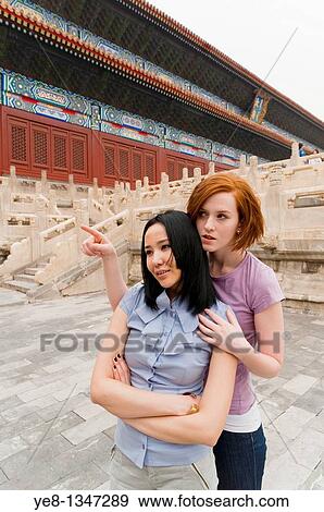 Stock Photo - Tourist pointing something out to her friend in The Forbidden City, Beijing, China, Asia MR. Fotosearch