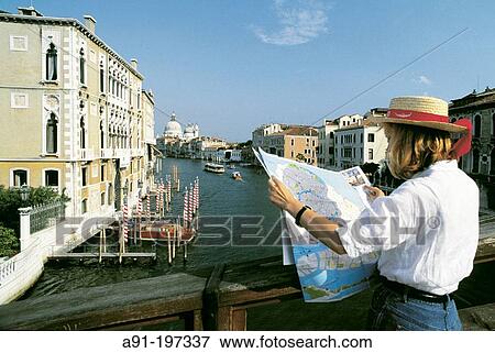 Tourist reading city map in front of Grand Canal. Venice. Italyn View Large Photo Image Stock Photo - Tourist reading city map in front of Grand Canal. Venice. Italyn. Fotosearch