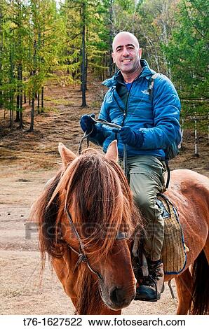 tourist riding horse on the steppe in Terelj National Park in Mongolia View Large Photo Image Stock Image - tourist riding horse on the steppe in Terelj National Park in Mongolia. Fotosearch
