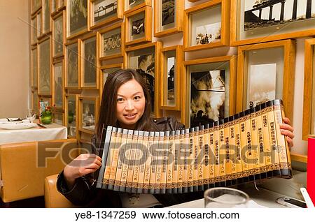 Tourist showing an old tea menu in a Sichuan cuisine restaurant, Haiyongxiang District, Shanghai, China, Asia MR View Large Photo Image Stock Photo - Tourist showing an old tea menu in a Sichuan cuisine restaurant, Haiyongxiang District, Shanghai, China, Asia MR. Fotosearch
