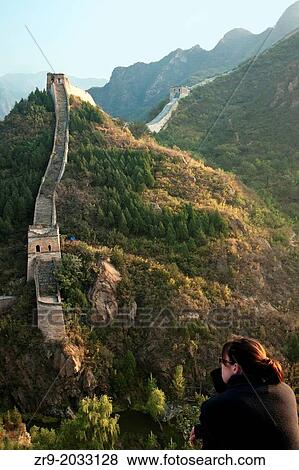 Tourist sits facing the Great Wall of China at Huanghua Cheng (Yellow Flower), Xishulyu, Jiuduhe Zhen, Huairou, China. View Large Photo Image Stock Photo - Tourist sits facing the Great Wall of China at Huanghua Cheng (Yellow Flower), Xishulyu, Jiuduhe Zhen, Huairou, China.. Fotosearch