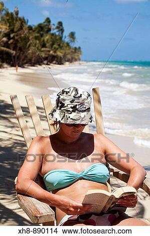 Tourist sitting in chair on beach reading book, Playa del Pablo, Little Corn Island, Corn Islands, Nicaragua View Large Photo Image Picture - Tourist sitting in chair on beach reading book, Playa del Pablo, Little Corn Island, Corn Islands, Nicaragua. Fotosearch