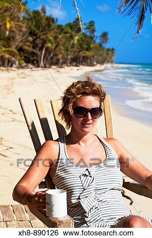 Tourist sitting in chair on beach, Playa del Pablo, Little Corn Island, Corn Islands, Nicaragua View Large Photo Image Stock Photograph - Tourist sitting in chair on beach, Playa del Pablo, Little Corn Island, Corn Islands, Nicaragua. Fotosearch