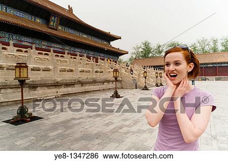 Tourist surprised watching something in The Forbidden City, Beijing, China, Asia MR View Large Photo Image Stock Photograph - Tourist surprised watching something in The Forbidden City, Beijing, China, Asia MR. Fotosearch