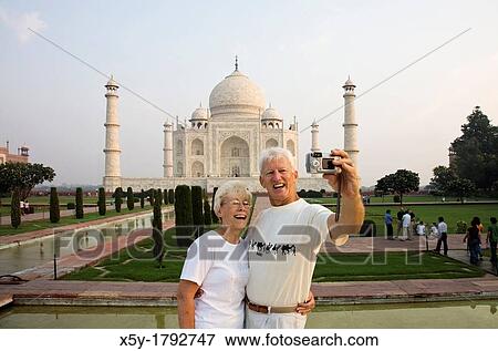 Tourist taking their picture atThe world famous Taj Mahal The Taj Mahal is a mausoleum located in Agra, India View Large Photo Image Stock Photo - Tourist taking their picture atThe world famous Taj Mahal The Taj Mahal is a mausoleum located in Agra, India. Fotosearch