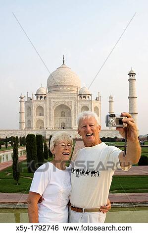 Stock Photograph - Tourist taking their picture atThe world famous Taj Mahal The Taj Mahal is a mausoleum located in Agra, India. Fotosearch