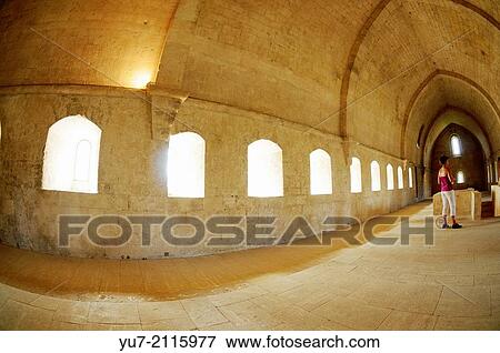 Stock Photo - Tourist visiting monk's dormitory in former Cistercian monastery Silvacane Abbey near La Roque-d? Antheron, Provence, France.. Fotosearch