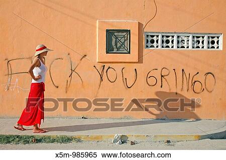 Tourist walking past a bit of anti-American grafitti on a wall in Playa del Carmen, Mexico View Large Photo Image Stock Photography - Tourist walking past a bit of anti-American grafitti on a wall in Playa del Carmen, Mexico. Fotosearch