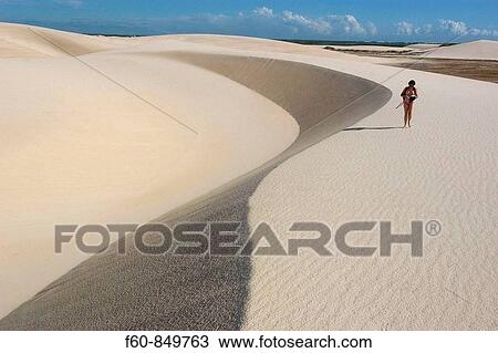 Tourist walks on the sand dunes of Lencois Maranhenses National Park, Santo Amaro, Maranh? o, Brazil View Large Photo Image Stock Image - Tourist walks on the sand dunes of Lencois Maranhenses National Park, Santo Amaro, Maranh? o, Brazil. Fotosearch