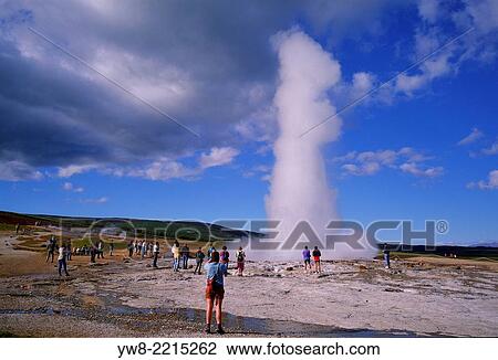 Stock Image - Tourist watching Strokkur Geyser erupting, Iceland.. Fotosearch