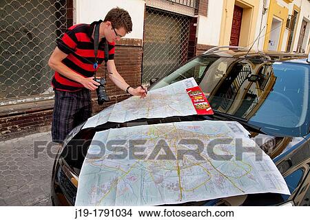 Tourist with map, Seville, Spain View Large Photo Image Picture - Tourist with map, Seville, Spain. Fotosearch