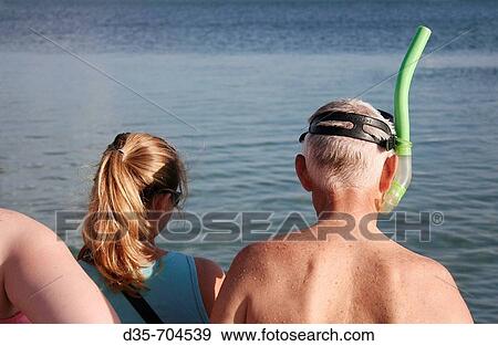 Stock Photo - Tourist with mask and snorkel at Monkey Mia Dolphin Lodge, Western Australia. Fotosearch