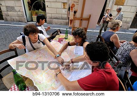 Stock Photograph - Tourists counsulting a map. Rome. Italy.. Fotosearch