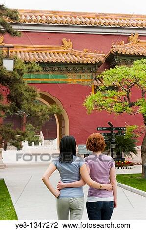 Stock Image - Tourists hugging each other in The Forbidden City, Beijing, China, Asia MR. Fotosearch