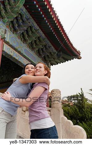 Stock Image - Tourists hugging each other in The Forbidden City, Beijing, China, Asia MR. Fotosearch