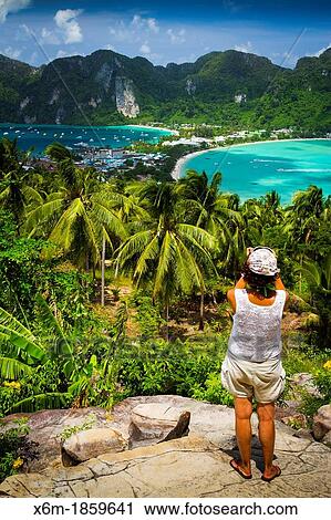Stock Image - Tourists in a viewpoint Phi Phi Don island Krabi province, Andaman Sea, Thailand. Fotosearch