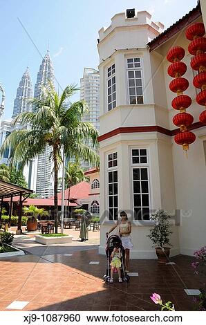 Tourists in Kuala Lumpur, Malaysia. the Petronas Towers in the background. View Large Photo Image Stock Image - Tourists in Kuala Lumpur, Malaysia. the Petronas Towers in the background.. Fotosearch