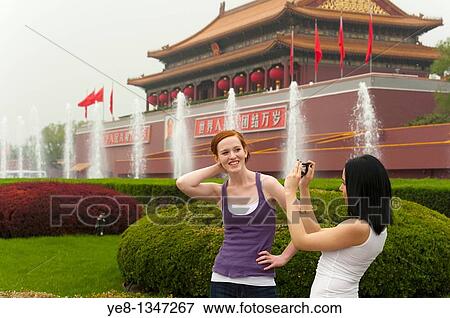 Tourists, one taking photos of the other, in front of The Gate of Heavenly Peace, The Forbidden City, Beijing, China, Asia MR View Large Photo Image Stock Photo - Tourists, one taking photos of the other, in front of The Gate of Heavenly Peace, The Forbidden City, Beijing, China, Asia MR. Fotosearch