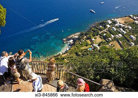 Tourists photographing view of Capri coastline from balcony at Villa San Michele, Anacapri, Capri, Italy View Large Photo Image Stock Photograph - Tourists photographing view of Capri coastline from balcony at Villa San Michele, Anacapri, Capri, Italy. Fotosearch