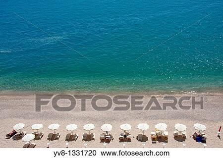 Tourists relaxing by the seaside in Puglia, Italy View Large Photo Image Stock Image - Tourists relaxing by the seaside in Puglia, Italy. Fotosearch