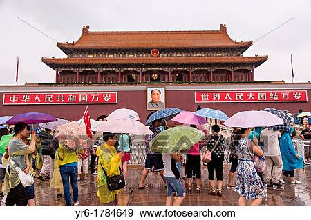 Tourists sheltering under umbrellas walk past the Gate of Heavenly Peace at the Forbidden City during a rainy summer day in Beijing, China View Large Photo Image Stock Photo - Tourists sheltering under umbrellas walk past the Gate of Heavenly Peace at the Forbidden City during a rainy summer day in Beijing, China. Fotosearch