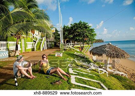 Tourists sitting on beach front outside dive shop, Little Corn Island, Corn Islands, Nicaragua View Large Photo Image Stock Photo - Tourists sitting on beach front outside dive shop, Little Corn Island, Corn Islands, Nicaragua. Fotosearch