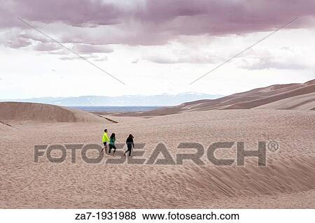 Tourists stroll along the dunes at The Great Sand Dunes National Park and Preserve in Colorado View Large Photo Image Stock Photo - Tourists stroll along the dunes at The Great Sand Dunes National Park and Preserve in Colorado. Fotosearch