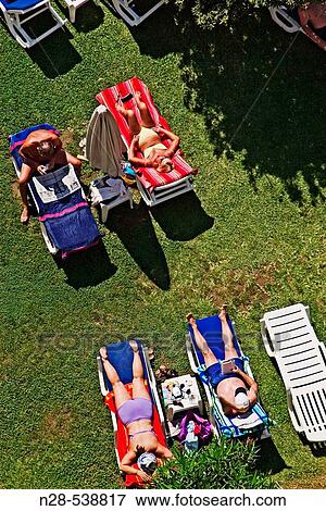 Tourists sunbathing at Hotel, Costa del Sol, Andalucia, Spain. View Large Photo Image Stock Photo - Tourists sunbathing at Hotel, Costa del Sol, Andalucia, Spain.. Fotosearch