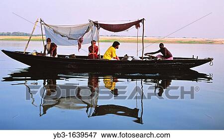 Tourists take a boat trip on the River Ganges, Varanasi, Uttar Pradesh, India View Large Photo Image Stock Photo - Tourists take a boat trip on the River Ganges, Varanasi, Uttar Pradesh, India. Fotosearch