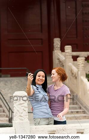 Stock Image - Tourists taking their own photograph in The Forbidden City, Beijing, China, Asia MR. Fotosearch