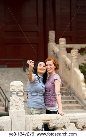 Tourists taking their own photograph in The Forbidden City, Beijing, China, Asia MR View Large Photo Image Stock Photo - Tourists taking their own photograph in The Forbidden City, Beijing, China, Asia MR. Fotosearch